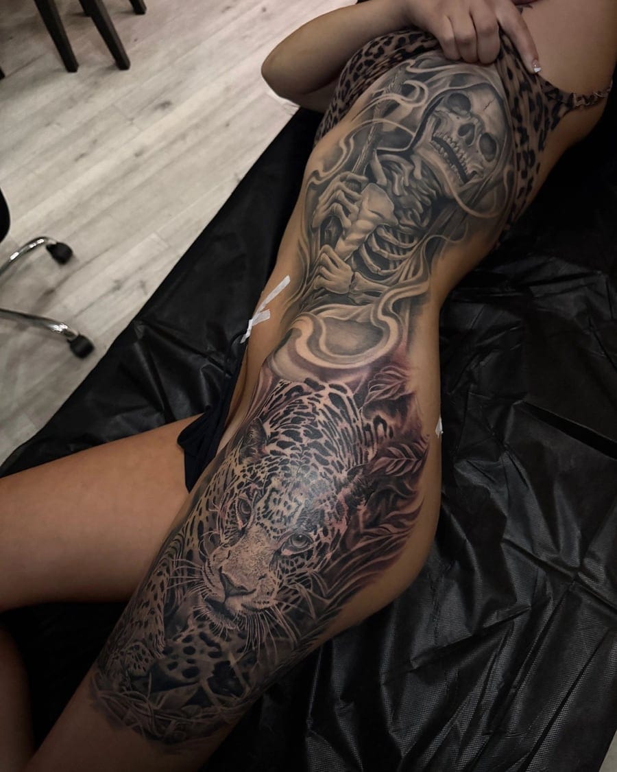 Black and grey thigh tattoo of a skeletal figure with a scythe above a leopard portrait