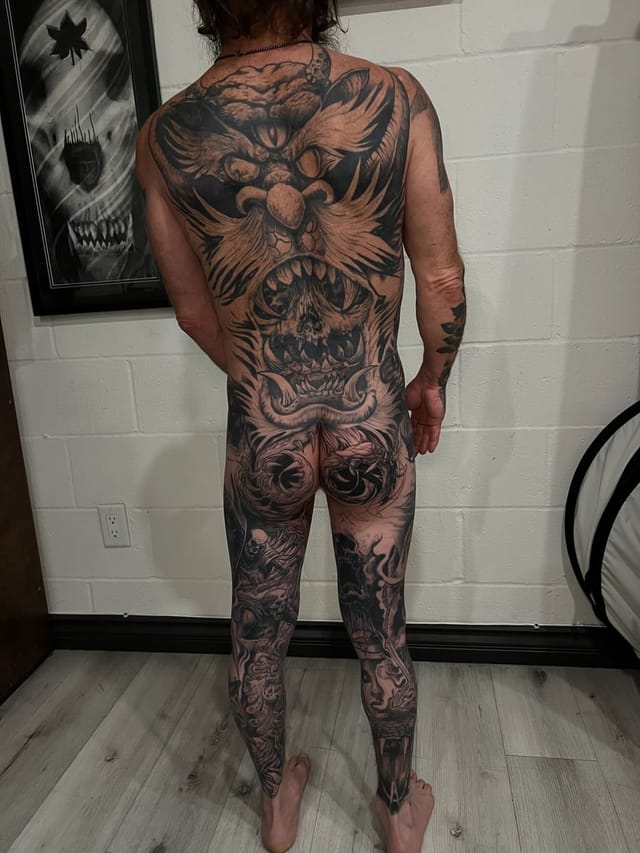 Full body blackwork oni demon tattoo suit covering back and legs, done at Broken Heart Tattoo in Hillcrest, San Diego