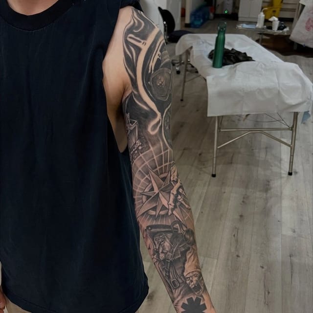 Black and grey realism sleeve tattoo with sci-fi and skull imagery, tattooed at Broken Heart Tattoo in Hillcrest, San Diego