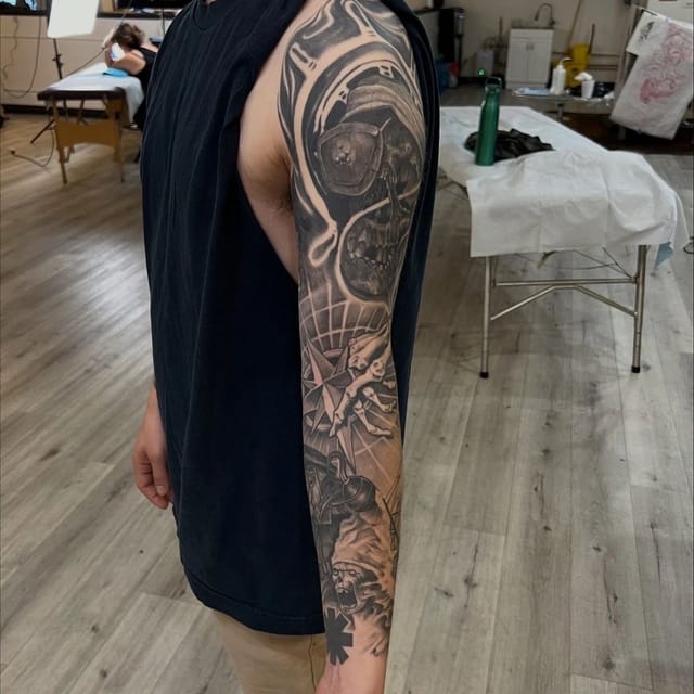 Black and grey sleeve tattoo in progress covering the full arm, tattooed at Broken Heart Tattoo in Hillcrest, San Diego